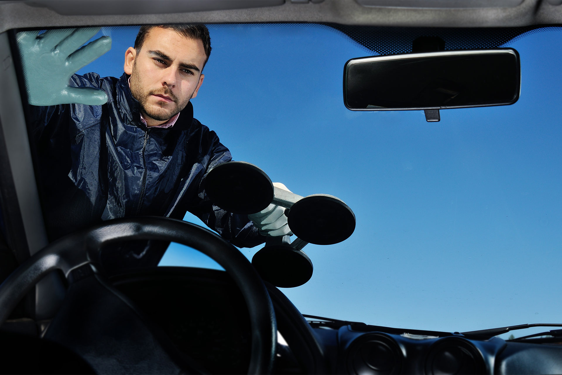 Auto glass technician replacing windshield